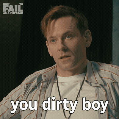 A Man Says " You Dirty Boy " In Front Of A How To Fail As A Popstar Poster GIF