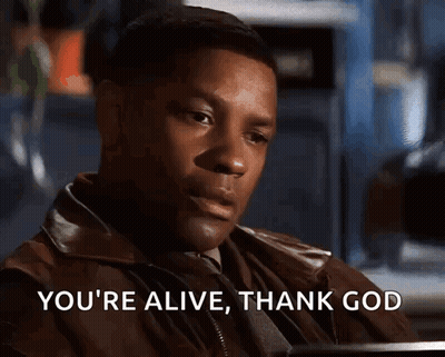 A Man Says " You 'Re Alive Thank God " While Sitting At A Table GIF