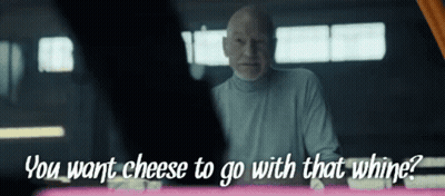 A Man Says " You Want Cheese To Go With That Whine " While Looking At Another Man GIF
