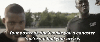 A Man Says " Your Postcode Don 'T Make You A Gangster You 'Re Not Bad Your Area Is " In Front Of Another Man GIF