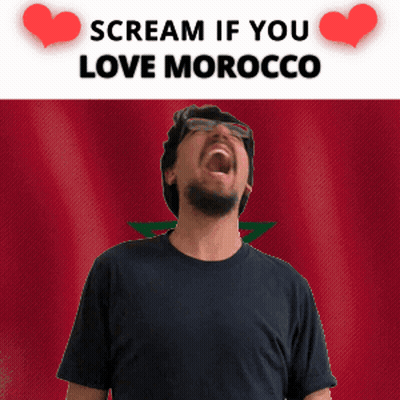 A Man Screaming In Front Of A Morocco Flag GIF