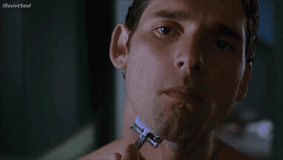 A Man Shaves His Neck With A Razor With Illusive Soul Written In The Upper Right Corner GIF