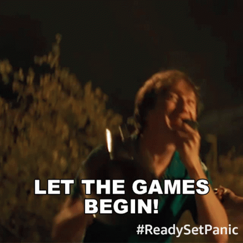 A Man Shouting Into A Megaphone With The Words Let The Games Begin Below Him GIF