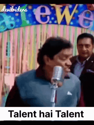 A Man Singing Into A Microphone In Front Of A Banner That Says Talent Hai Talent GIF