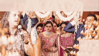 A Man Singing Into A Microphone In Front Of A Bride GIF