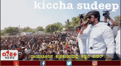 A Man Singing Into A Microphone In Front Of A Crowd With The Words Kiccha Sudeep On The Bottom GIF