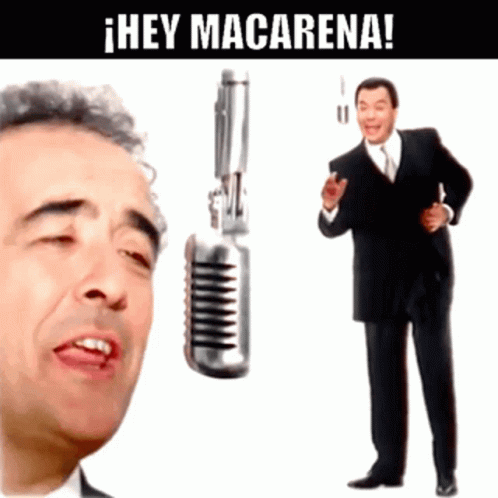 Man Singing Into Microphone Next To Man With Gun GIF