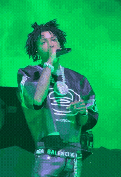 A Man Singing Into A Microphone Wearing A Balenciaga Belt GIF