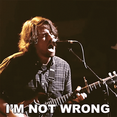 A Man Singing Into A Microphone While Playing A Guitar With The Words " I 'M Not Wrong " Above Him GIF