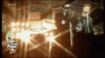 A Man Singing Into A Microphone While Wearing A Shirt That Says " I 'M With " GIF