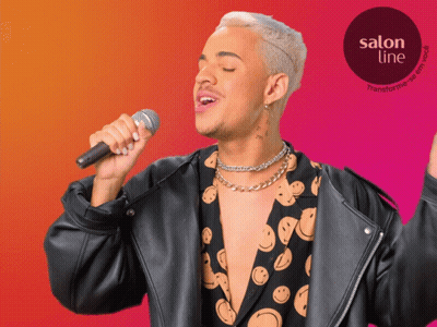 A Man Singing Into A Microphone With A Salon Line Logo In The Corner GIF