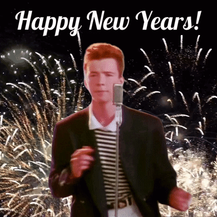A Man Singing Into A Microphone With Fireworks In The Background And The Words Happy New Years Written Above Him GIF