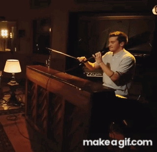 A Man Singing Into A Microphone With Make A Gif.com Written On The Bottom GIF