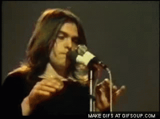 A Man Singing Into A Microphone With Make Gifs At Gifsoup.com At The Bottom Of The Screen GIF