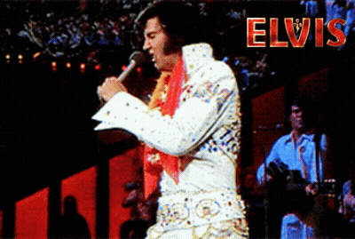 A Man Singing Into A Microphone With The Word Elvis In Red GIF