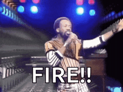 A Man Singing Into A Microphone With The Word Fire Written On It GIF