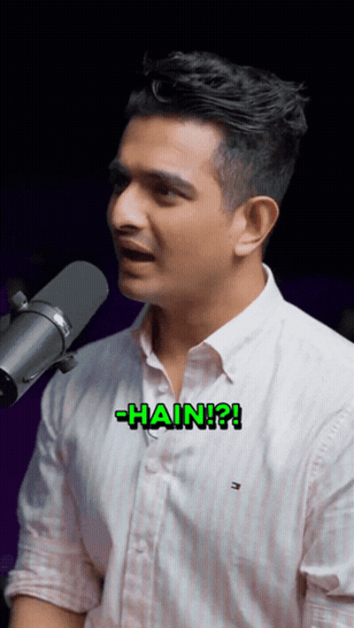 A Man Singing Into A Microphone With The Word Hain Written On His Chest GIF