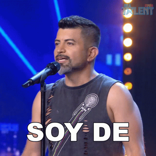 A Man Singing Into A Microphone With The Word Soy De Written In White GIF