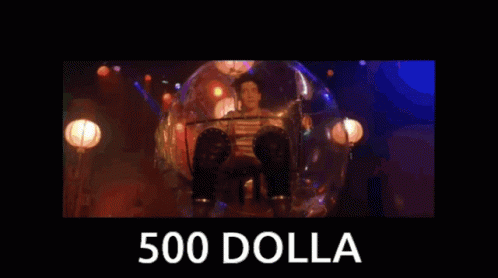 A Man Singing Into A Microphone With The Words 500 Dolla Behind Him GIF