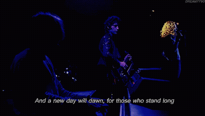 A Man Singing Into A Microphone With The Words " And The Forests Will Echo With Laughter " Next To Him GIF