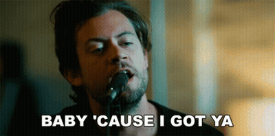 A Man Singing Into A Microphone With The Words Baby Cause I Got Ya Written Below Him GIF
