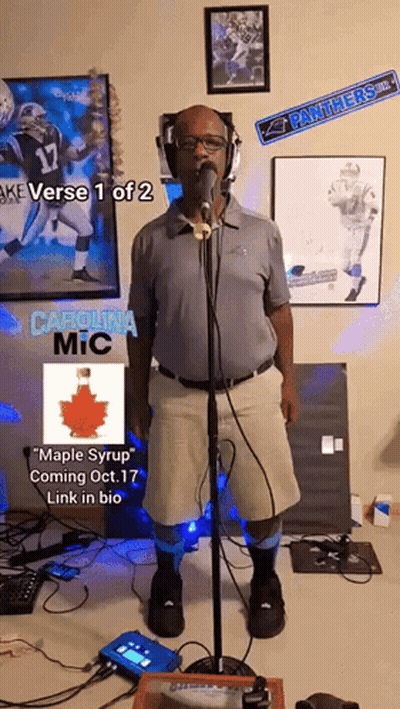 A Man Singing Into A Microphone With The Words Carolina Mic On The Bottom Right GIF