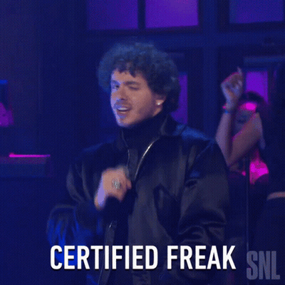 A Man Singing Into A Microphone With The Words Certified Freak Snl Below Him GIF