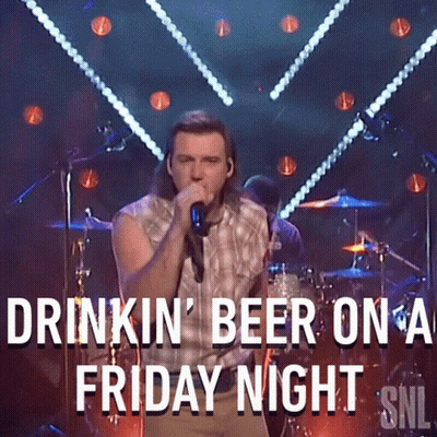 A Man Singing Into A Microphone With The Words Drinkin ' Beer On A Friday Night Snl GIF