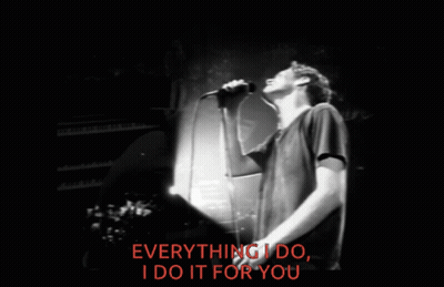 A Man Singing Into A Microphone With The Words Everything I Do I Do It For You Behind Him GIF