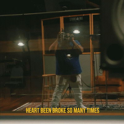 A Man Singing Into A Microphone With The Words Heart Been Broke So Many Times GIF