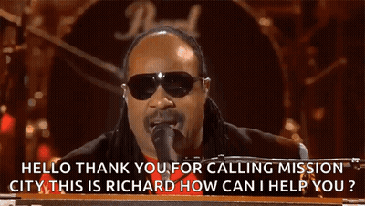 A Man Singing Into A Microphone With The Words Hello Thank You For Calling Mission City On The Bottom GIF