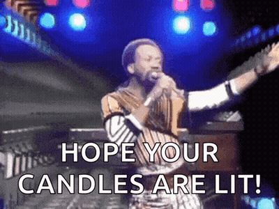 A Man Singing Into A Microphone With The Words Hope Your Candles Are Lit Written Below Him GIF