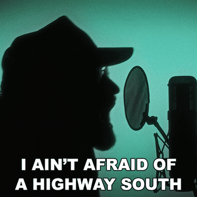 A Man Singing Into A Microphone With The Words " I Ain 'T Afraid Of A Highway South " Below Him GIF