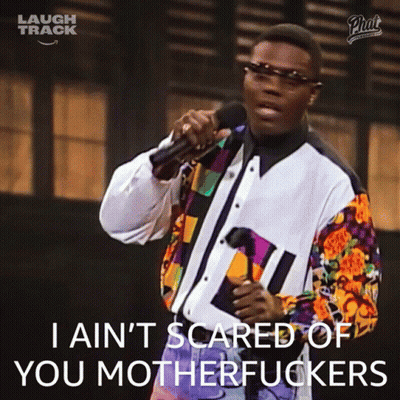 A Man Singing Into A Microphone With The Words I Ain T Scared Of You Motherfuckers GIF