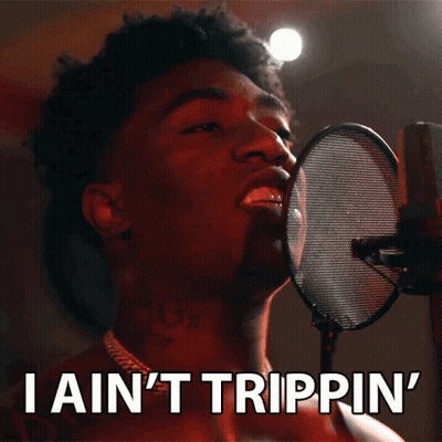 A Man Singing Into A Microphone With The Words " I Ain 'T Trippin ' " Below Him GIF