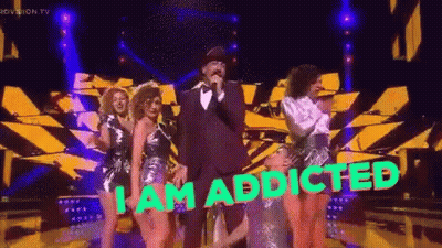 A Man Singing Into A Microphone With The Words " I Am Addicted " On The Bottom GIF