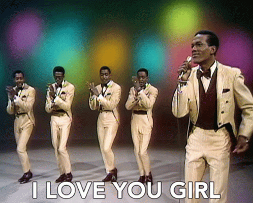 A Man Singing Into A Microphone With The Words " I Love You Girl " Behind Him GIF