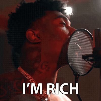 A Man Singing Into A Microphone With The Words I 'M Rich Behind Him GIF