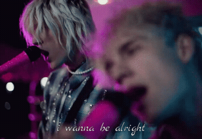 A Man Singing Into A Microphone With The Words I Wanna Be Alright Above Him GIF