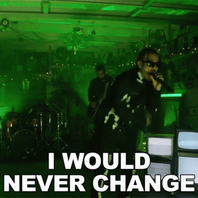 A Man Singing Into A Microphone With The Words " I Would Never Change " Below Him GIF