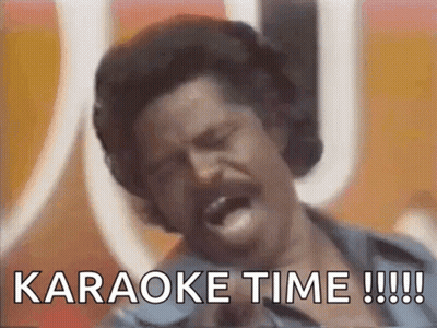 A Man Singing Into A Microphone With The Words " Karaoke Time !!! " Written Below Him GIF