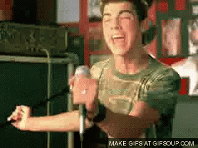 a man singing into a microphone with the words make gifs at gifsoup.com below