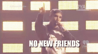 A Man Singing Into A Microphone With The Words " No New Friends " On The Bottom GIF