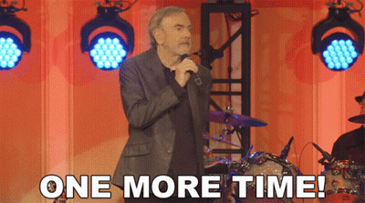 A Man Singing Into A Microphone With The Words " One More Time " Below Him GIF