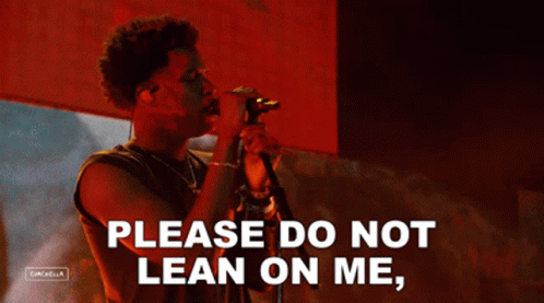 A Man Singing Into A Microphone With The Words Please Do Not Lean On Me On The Bottom GIF