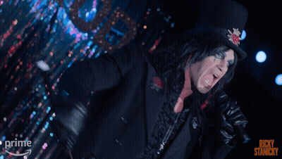 A Man Singing Into A Microphone With The Words Ricky Stancky On The Bottom Right GIF