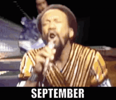 A Man Singing Into A Microphone With The Words September Written Below Him GIF
