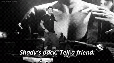 A Man Singing Into A Microphone With The Words Shady 'S Back Tell A Friend On The Bottom GIF