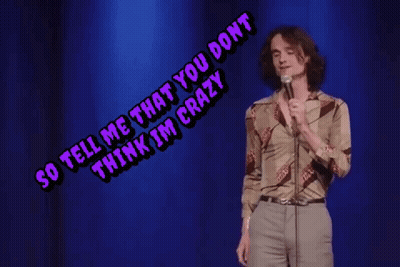 A Man Singing Into A Microphone With The Words So Tell Me That You Don T Think I 'M Crazy Above Him GIF