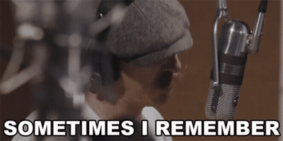 A Man Singing Into A Microphone With The Words " Sometimes I Remember " Below Him GIF